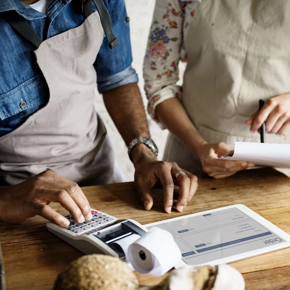 Small business partners calculate their Colorado bookeeping savings.